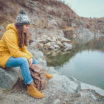 Hiker resting beside a mountain lake